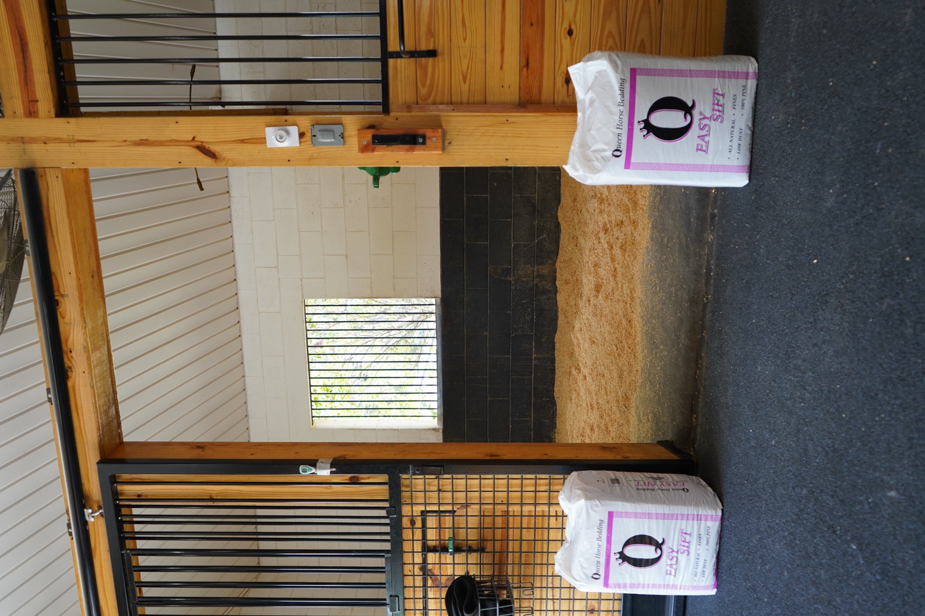 A freshly bedded stall with bags of Easy Sift waiting at the door.